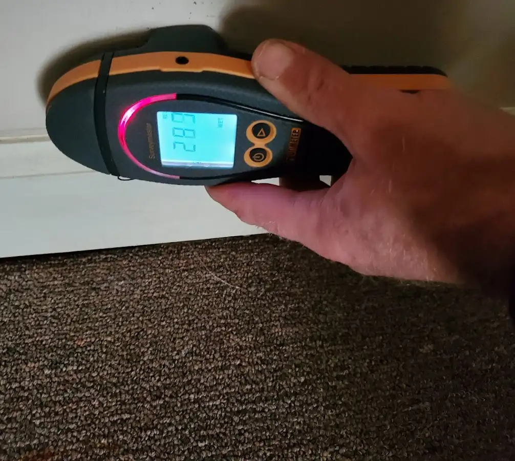 Moisture detection at baseboard during Storm Damage Restoration in Fair Lakes